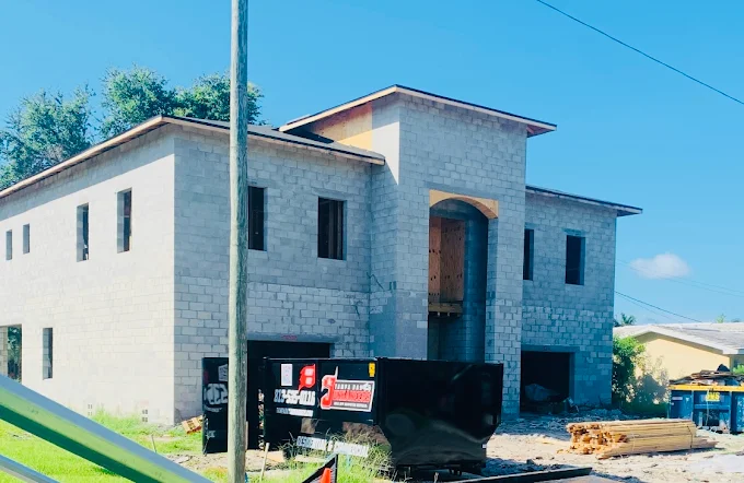 Tampa Bay Junkaneers dumpster at active cinder block construction site
